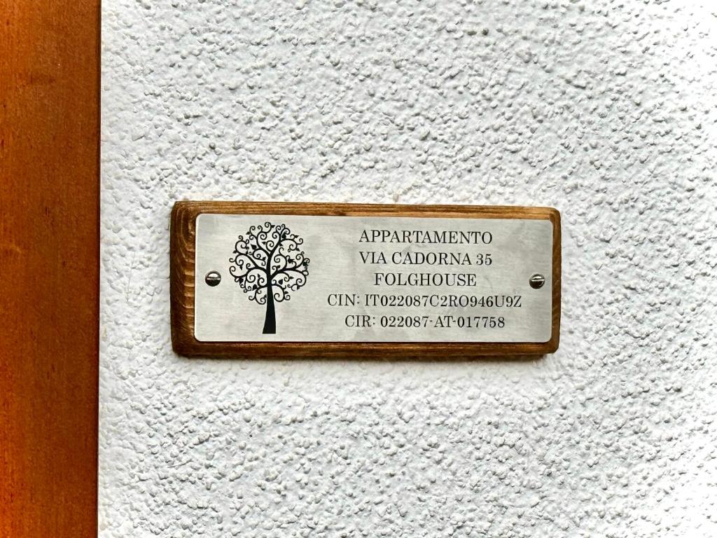 a sign on a wall with a tree on it at Folghouse in Folgaria