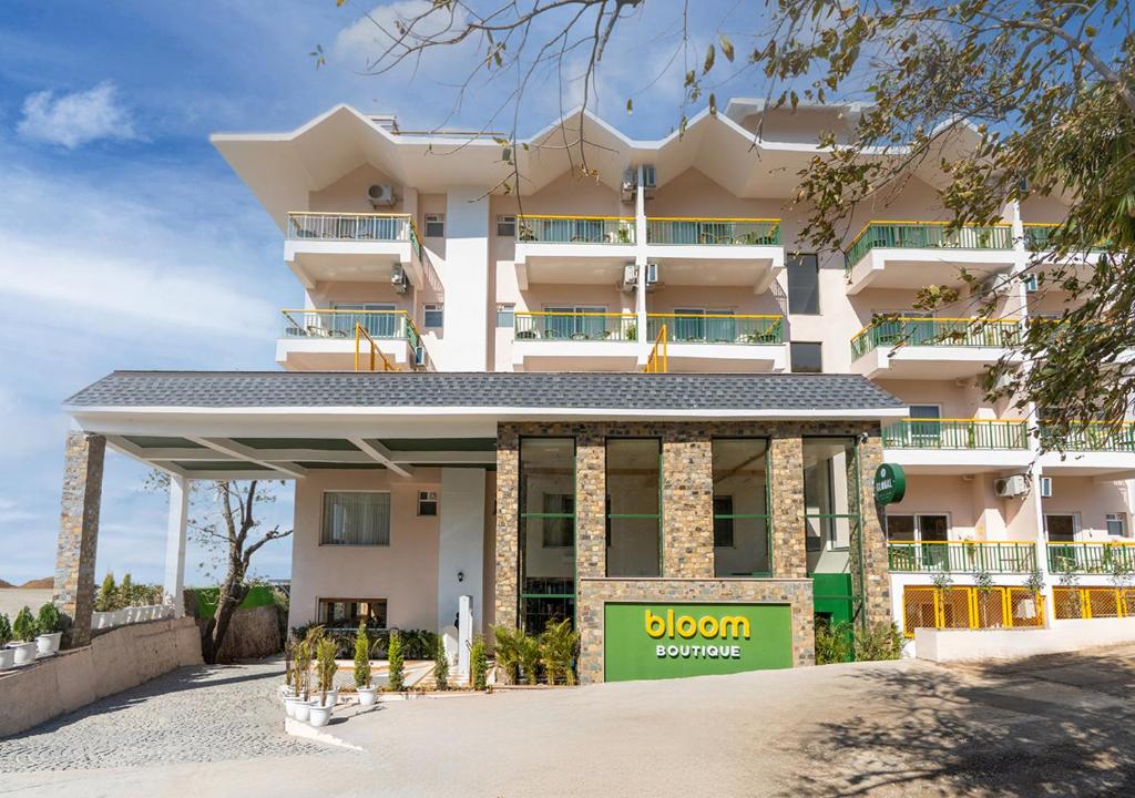 a large white building with a sign in front of it at Bloom Boutique - Rishikesh Hills in Rishīkesh