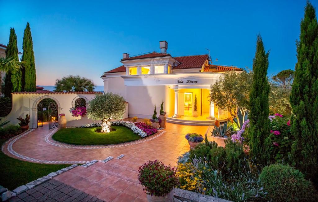 a large house with a garden and a driveway at Villa Palace Clara Apartment 2 island Krk by Vill in Malinska