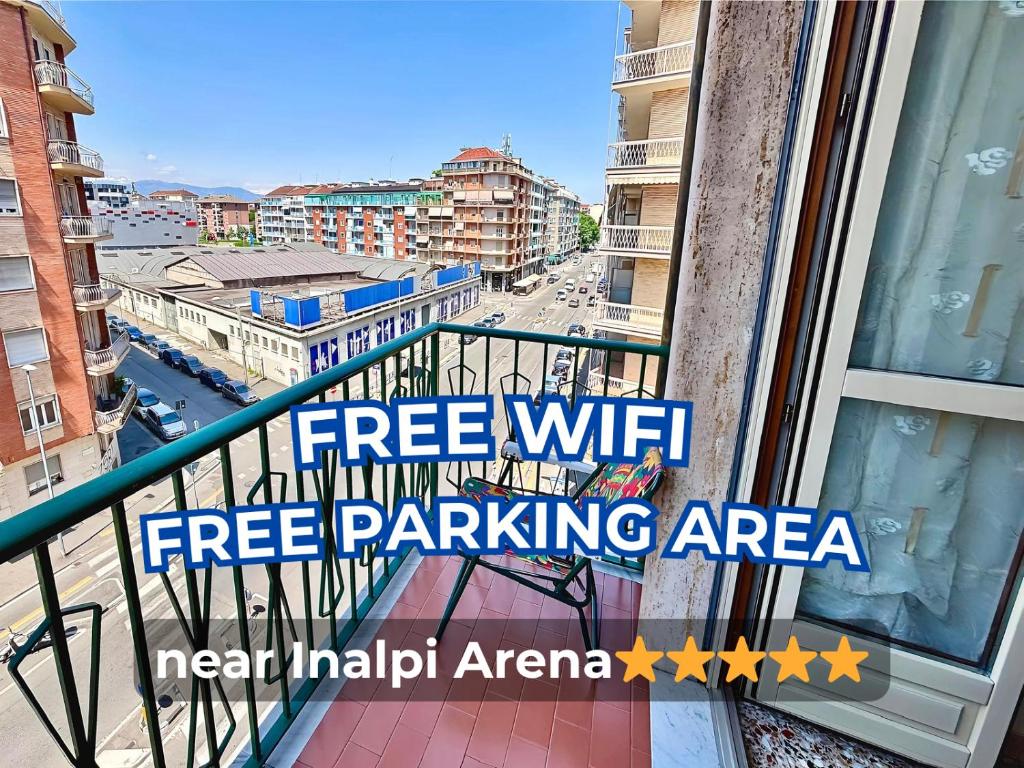 a balcony with a sign that reads free wifi free parking area at Chez Louise, free wi-fi & 5 minutes from InalpiArena in Turin