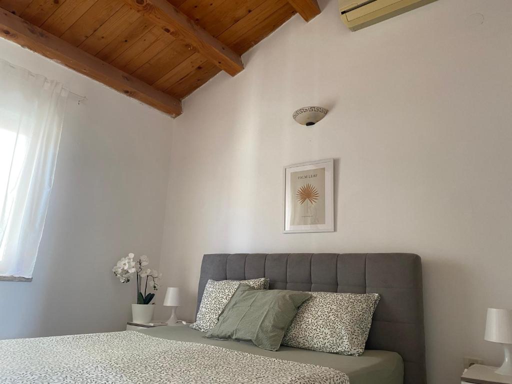 a bedroom with a bed in a room with white walls at Guest House Marta in Rovinj