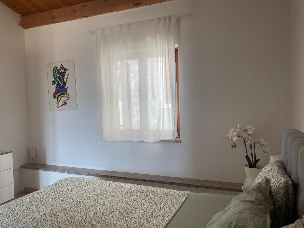 a white room with a window and a bed at Guest House Marta in Rovinj