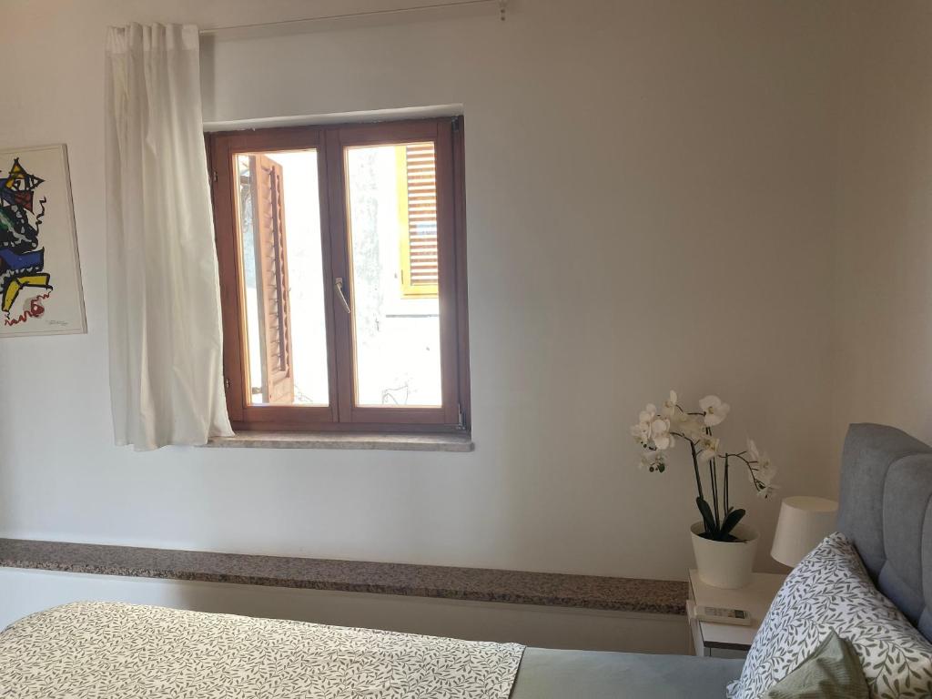 a white room with a window and a couch at Guest House Marta in Rovinj