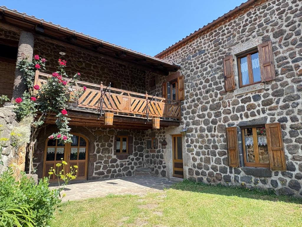 a building with a balcony on the side of it at Le Bouffadou in Le Bouchet-Saint-Nicolas