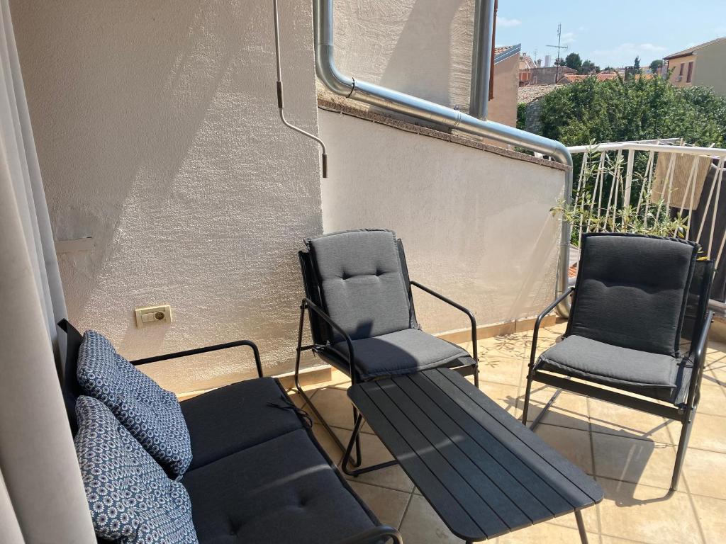 two chairs and a bench on a balcony at Guest House Marta in Rovinj