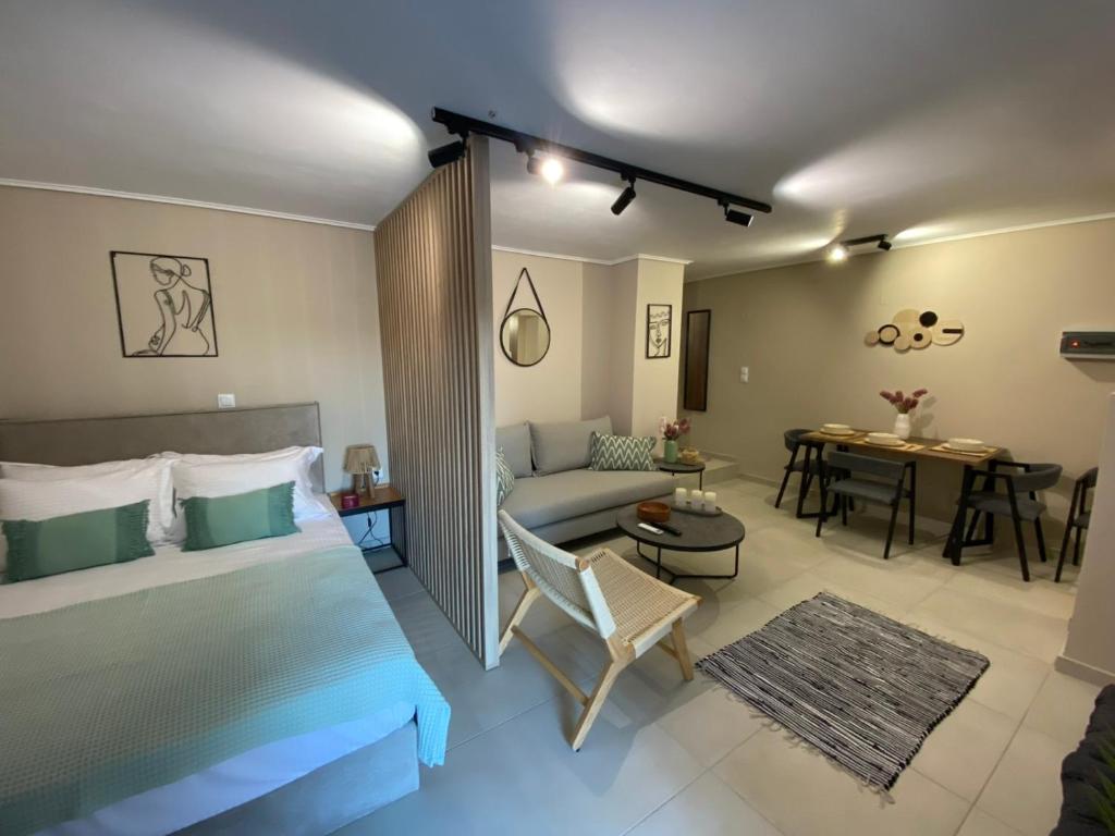 a bedroom with a bed and a living room with a couch at Harmony in Mytilini