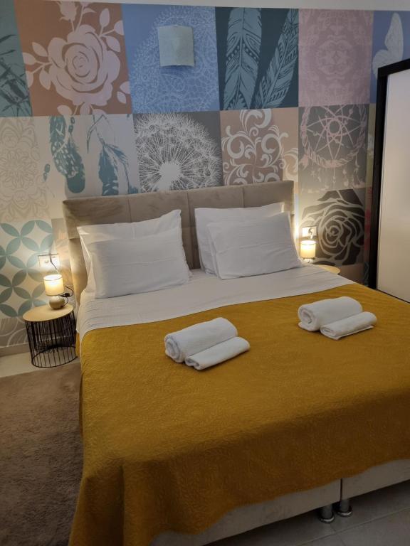 a bedroom with a bed with two towels on it at Apartman Ulrich in Lukovo