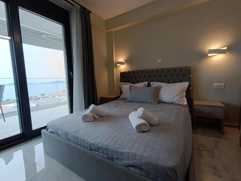 a bedroom with a bed with towels on it at ALTA MARE in Nea Peramos
