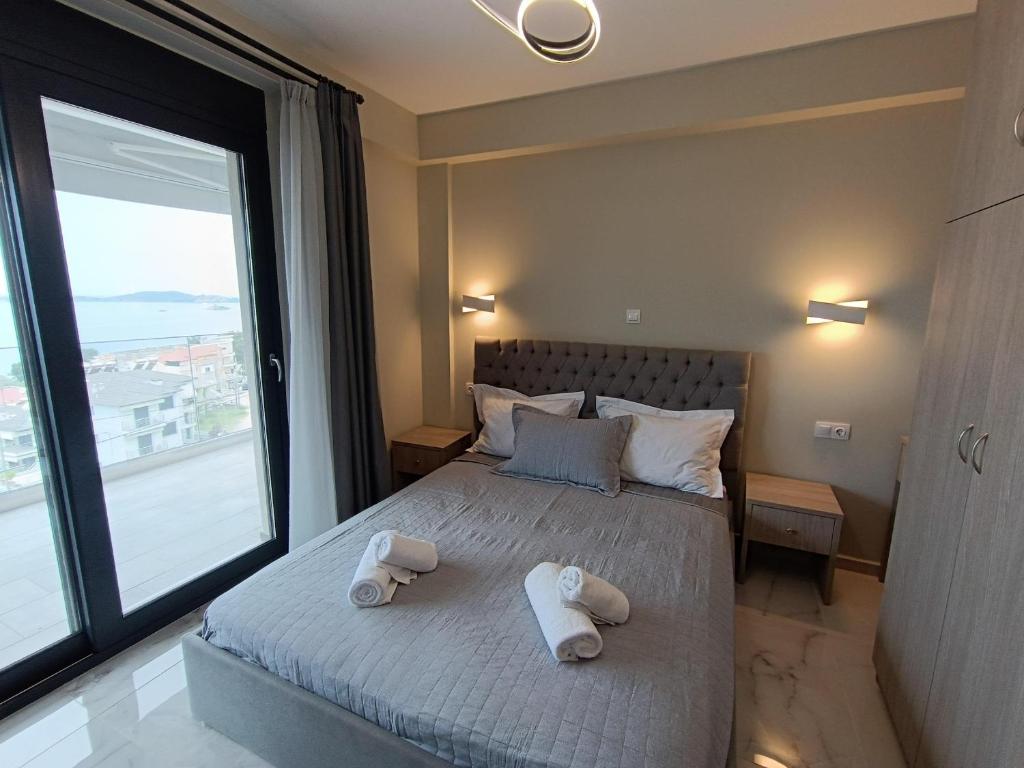 a bedroom with a bed with two towels on it at ALTA MARE in Nea Peramos