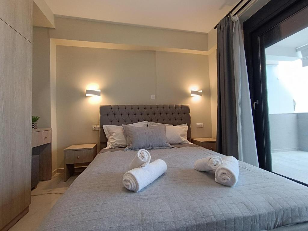 a bedroom with a bed with towels on it at ALTA MARE in Nea Peramos