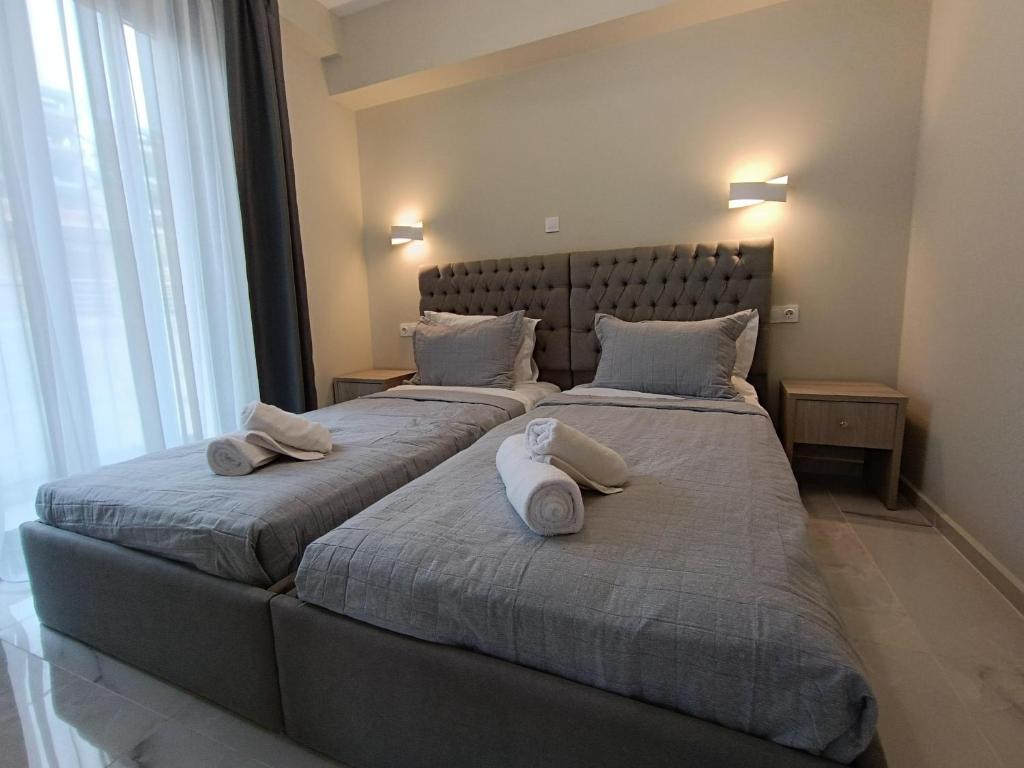 two beds in a bedroom with two pillows on them at ALTA MARE in Nea Peramos