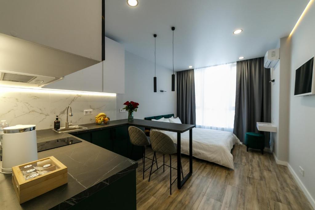 a kitchen with a sink and a bed in a room at VS Apartments in Kyiv