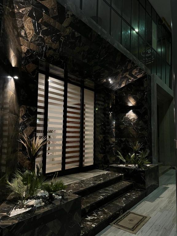 a lobby with stairs and a window in a building at Pacha hotel in Sfax