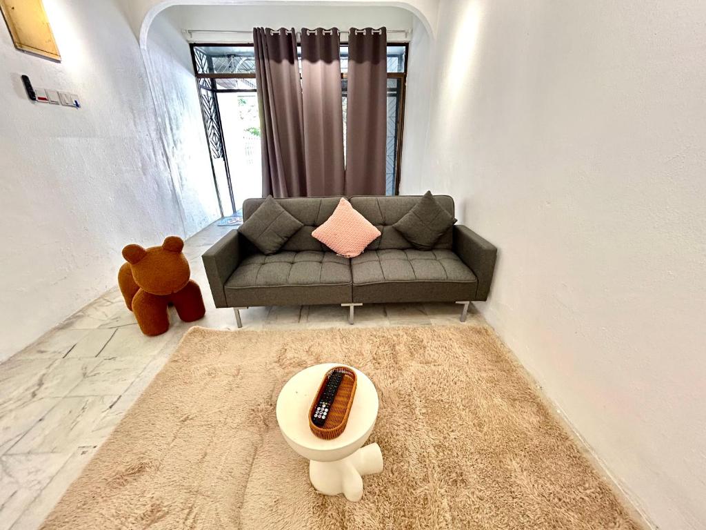 a living room with a couch and a teddy bear at CozySukun40#6pax#Netflix#NearIconCity#BukitMertajam in Bukit Mertajam