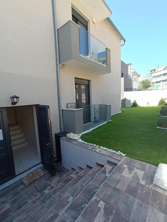 a house with a green lawn in front of it at ALTA MARE in Nea Peramos