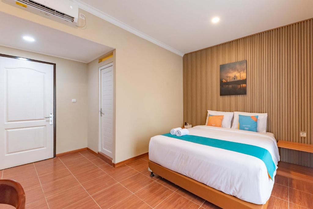 Ένα ή περισσότερα κρεβάτια σε δωμάτιο στο Sans Vibes Surapati Konforta Hotel