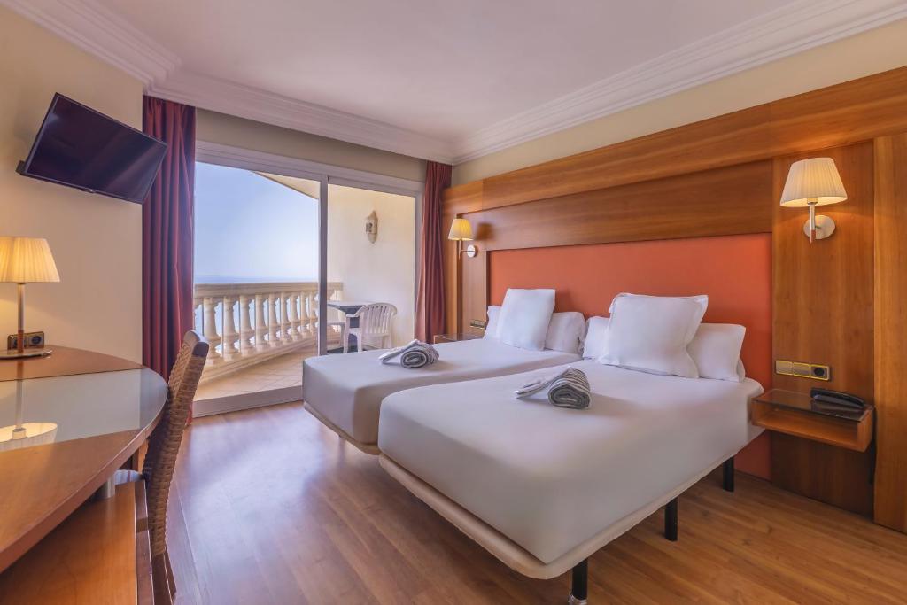 Postel nebo postele na pokoji v ubytování Hotel Moon Dreams Portomagno