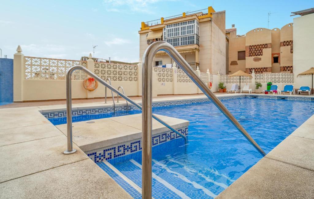a swimming pool with a set of stairs leading to a building at Gorgeous Apartment In Fuengirola in Fuengirola