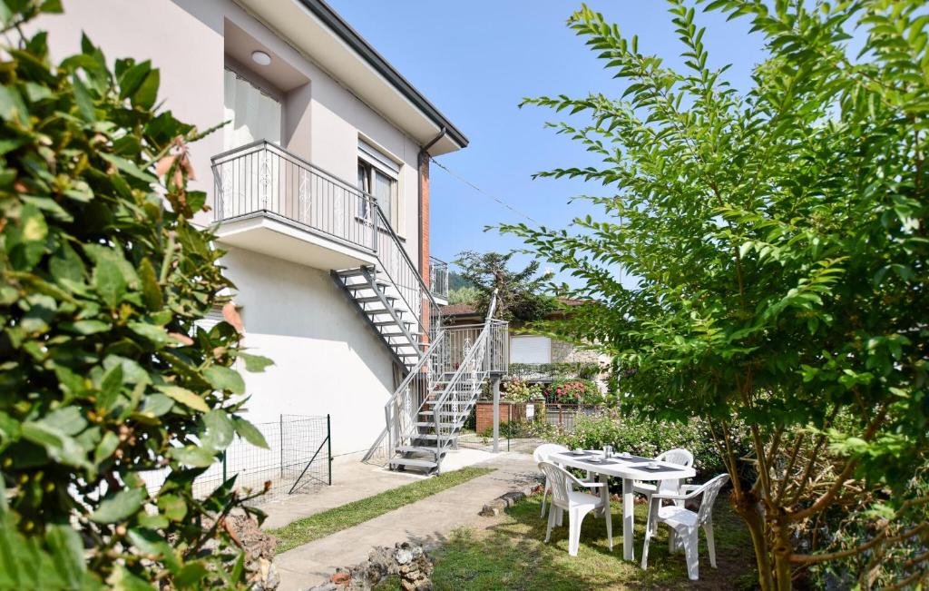 a garden with a table and chairs in front of a building at Beautiful Apartment In Piano Di Mommio in Piano di Mommio