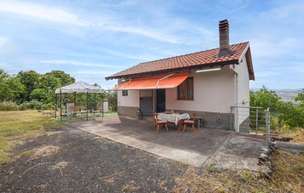 a small white house with a table and chairs at Beautiful Home In Bronte With Wifi in Maletto