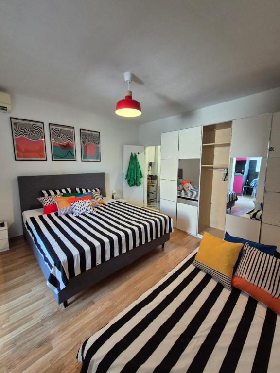 a bedroom with a large bed and a striped rug at Apartment Mirna in Baška Voda