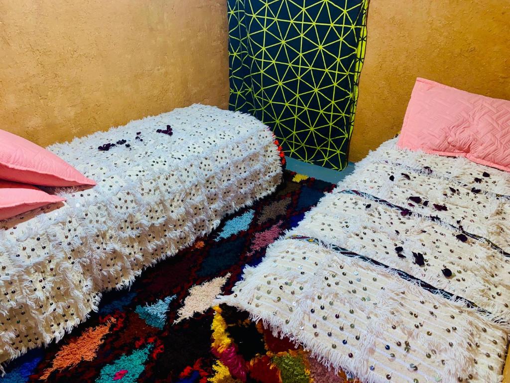 Gulta vai gultas numurā naktsmītnē Gite Amani Guest House