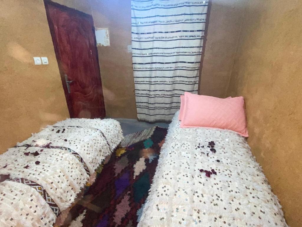 Gulta vai gultas numurā naktsmītnē Gite Amani Guest House