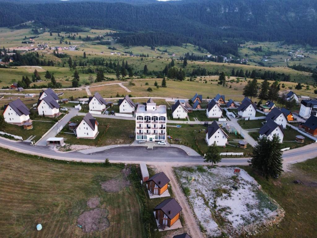 an aerial view of a village with a large building at Oaza Mira Hotel & Resort-فندق ومنتجع واحة الهدوء in Vlasic