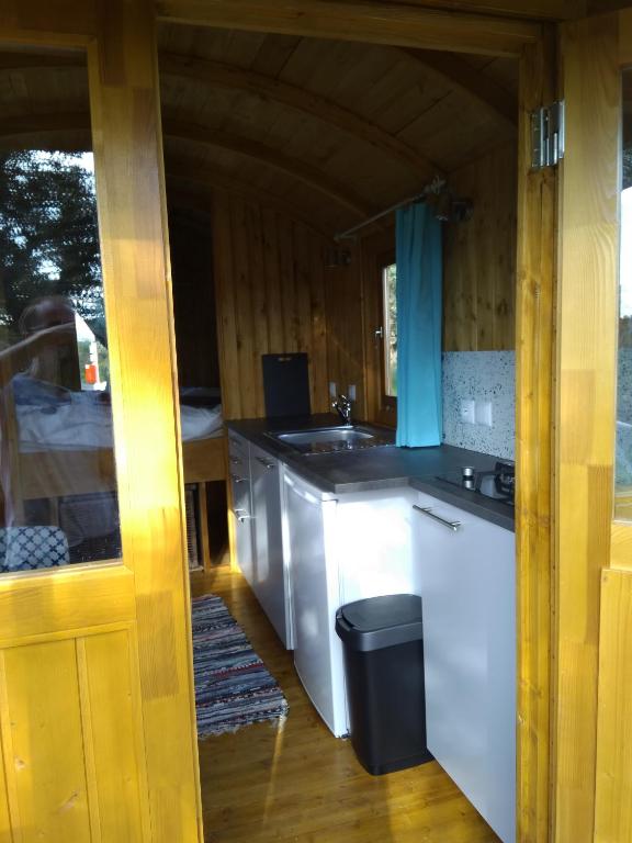 a kitchen with a stove and a counter top at Gypsy caravan op de camping in Ourique