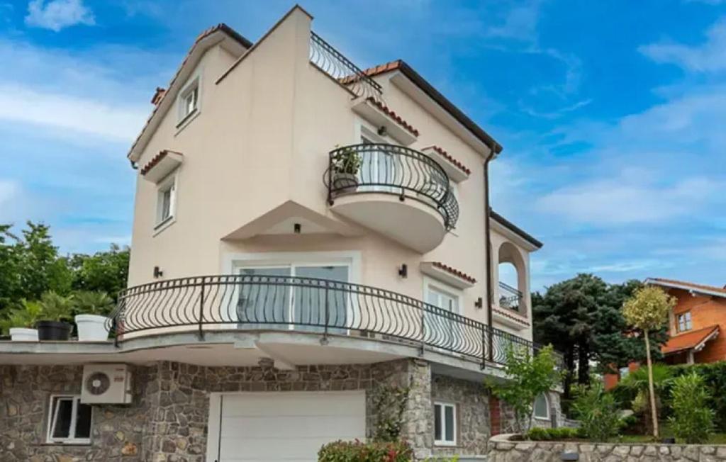 a large white house with a balcony at Villa Mihaela by Villas Guide in Rukavac