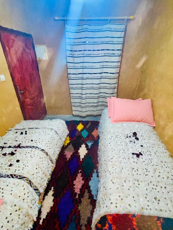 Gulta vai gultas numurā naktsmītnē Gite Amani Guest House
