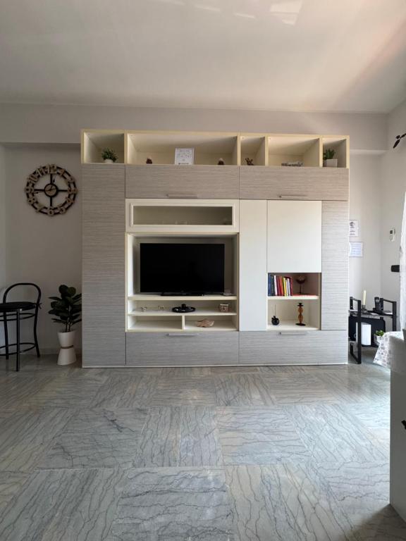 a living room with a large entertainment center with a tv at Trilocale vicino al mare in Lido di Ostia