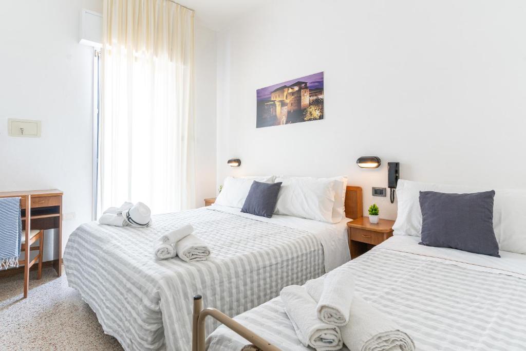 Postel nebo postele na pokoji v ubytování Hotel Lariana