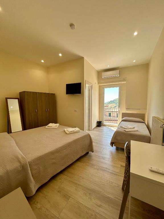 a hotel room with two beds and a television at B&b Al Centro Nicosia in Nicosia