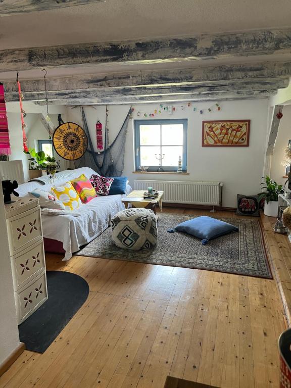 a living room with a bed and a table at Hering FeWo II Apartment Balcony in Wiek auf Rügen 