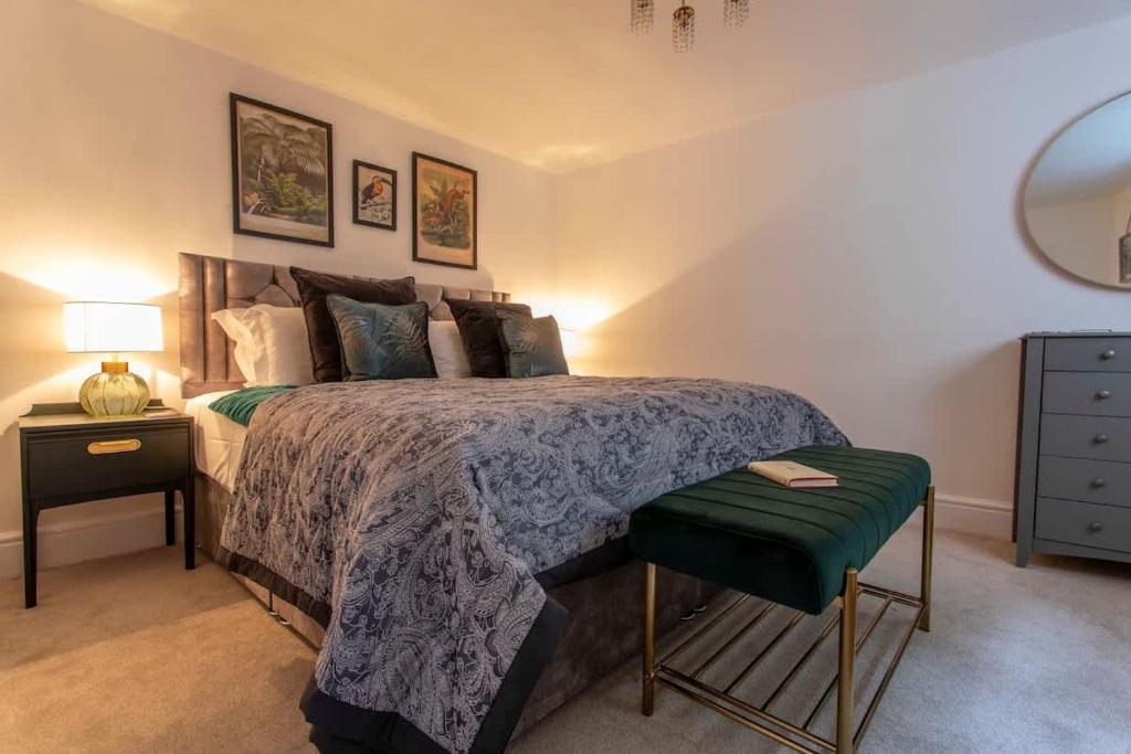 a bedroom with a bed with a green comforter at Central, beautiful home - with parking in Bradford on Avon
