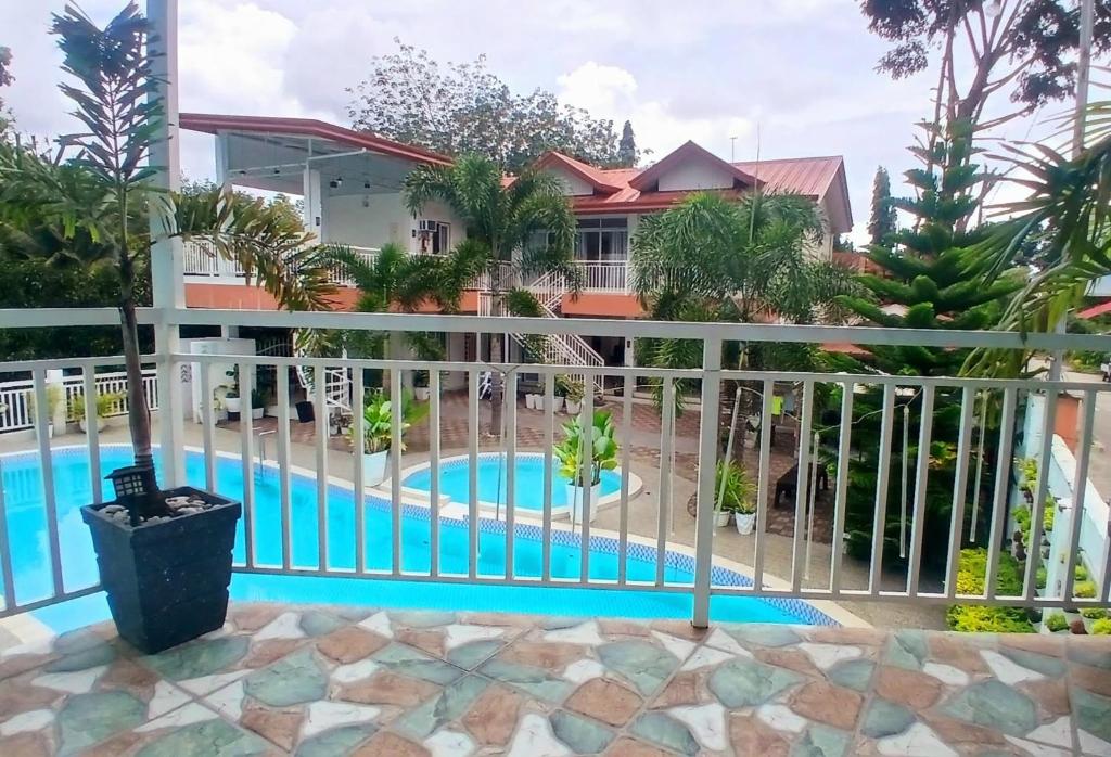 a view from the balcony of a house with a swimming pool at Carms Villa Resort in Kidapawan