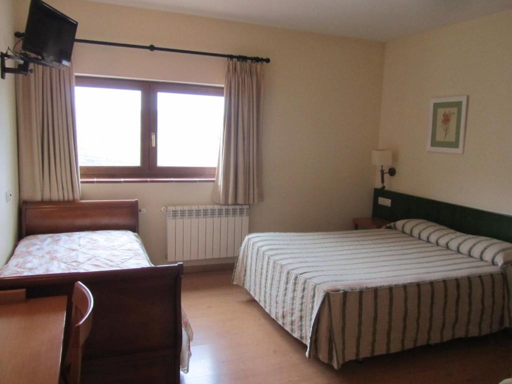 Postel nebo postele na pokoji v ubytování Hotel Galayos