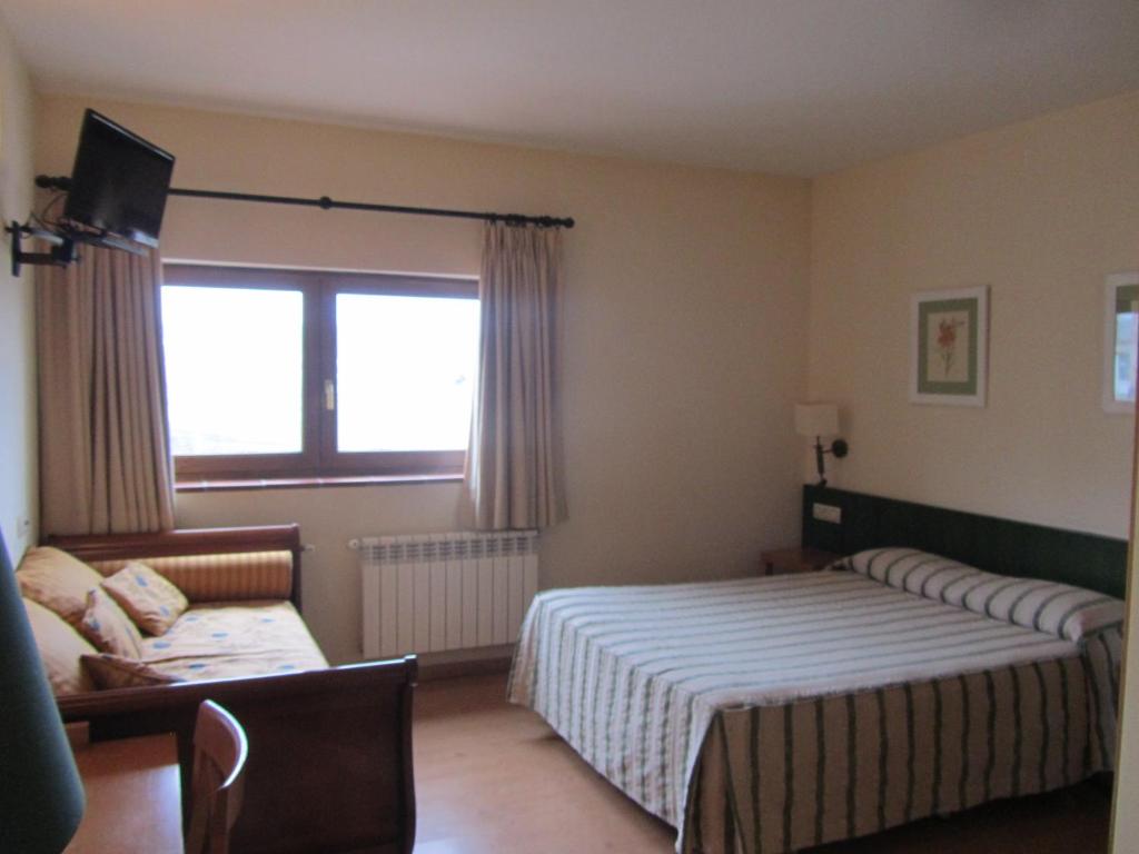 Postel nebo postele na pokoji v ubytování Hotel Galayos