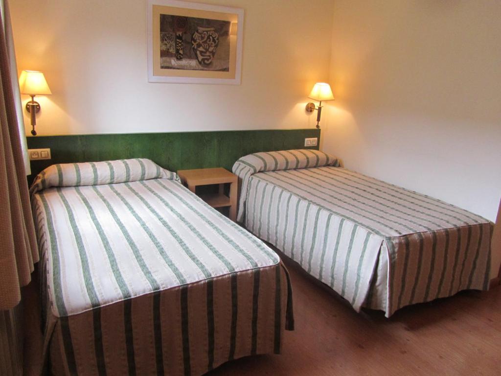 Postel nebo postele na pokoji v ubytování Hotel Galayos