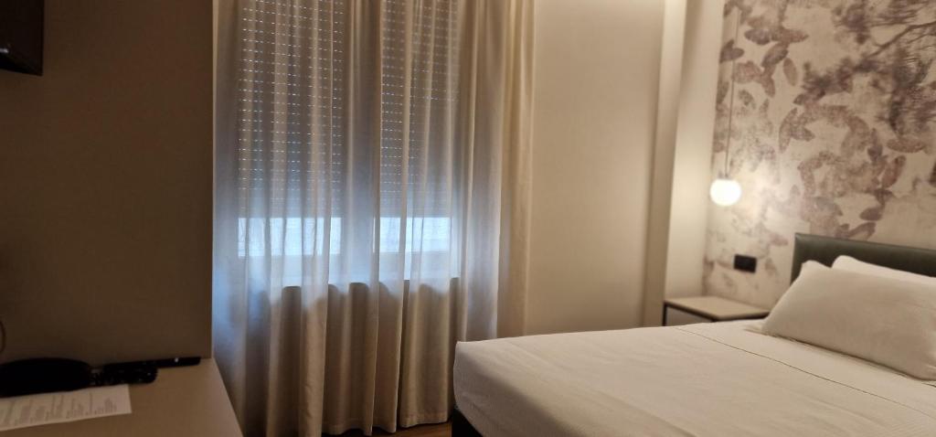 Postel nebo postele na pokoji v ubytování Hotel La Rocca