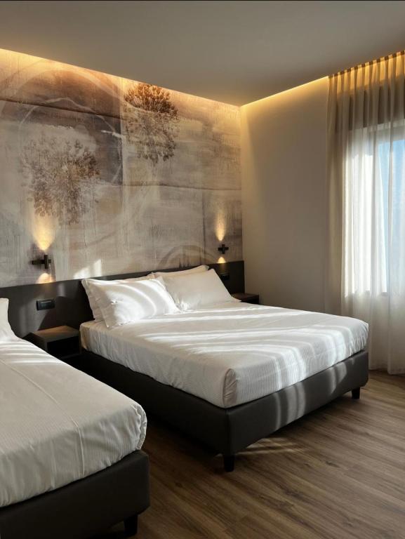 Postel nebo postele na pokoji v ubytování Hotel La Rocca
