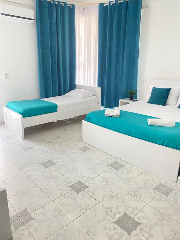 Postel nebo postele na pokoji v ubytování Rai Rooms