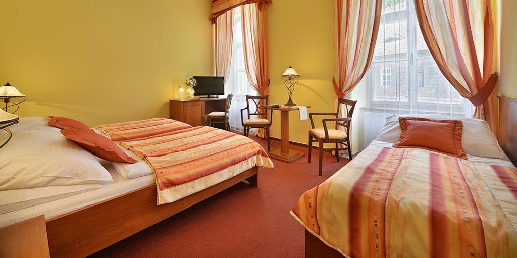 Postel nebo postele na pokoji v ubytování Residence Knížecí Dvůr