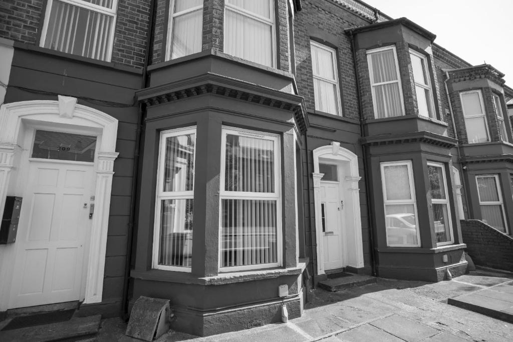 a black and white photo of a house with white doors at Albert Lodge in Belfast