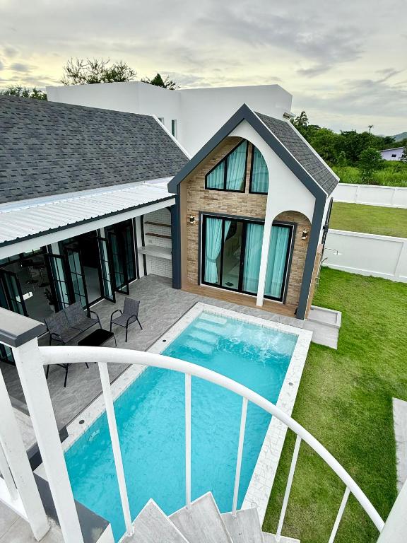 a swimming pool in the yard of a house at N&C Mountain Pool Villa Huahin in Hua Hin