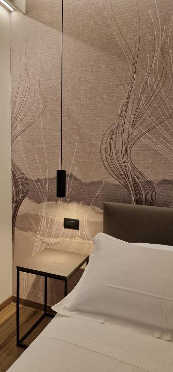 Postel nebo postele na pokoji v ubytování Hotel La Rocca