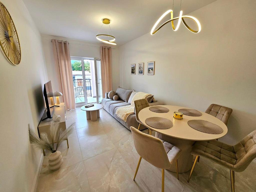 a living room with a table and a couch at Apartament BalticSea 11 Mielno in Mielno