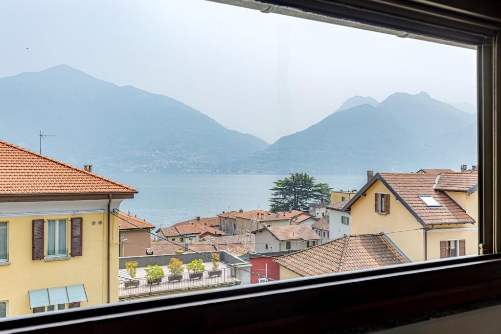 a view from a window of a town with mountains at ROMANTIC COMO HIDEAWAY with private parking and AirCon in Acquaseria