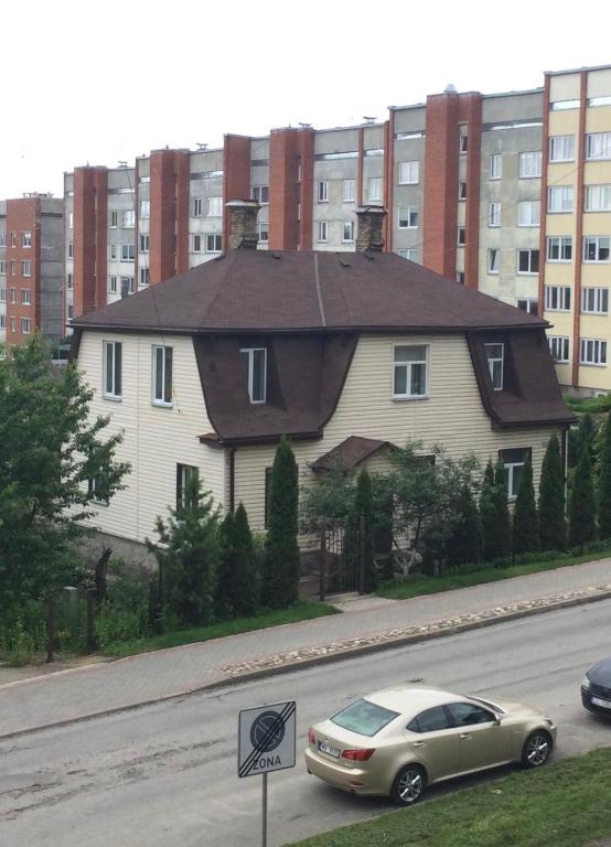 a house with a car parked on the side of a street at AV ApartmenT in Rēzekne